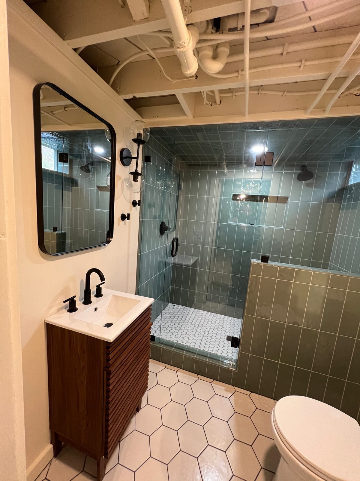 Basement bathroom with glazed green tile steam shower and walnut slat vanity in Maplewood, SW Portland — K&H Construction