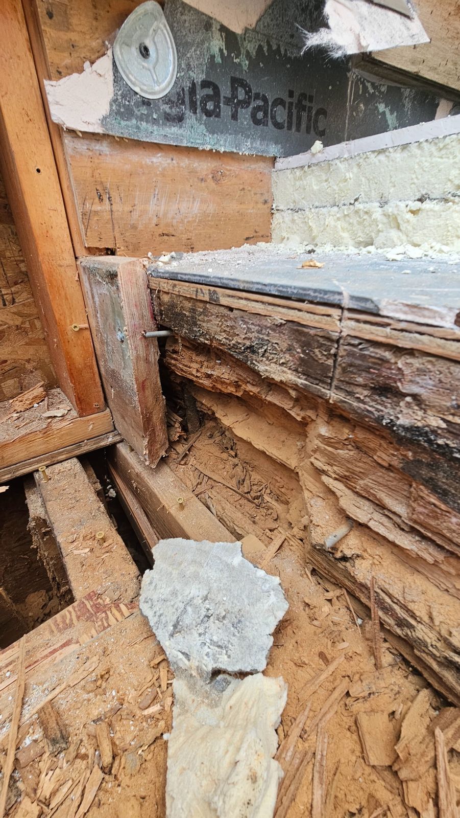 Dry rot damage in a parapet sill and sheathing opened up during a NW Portland condo repair — K&H Construction
