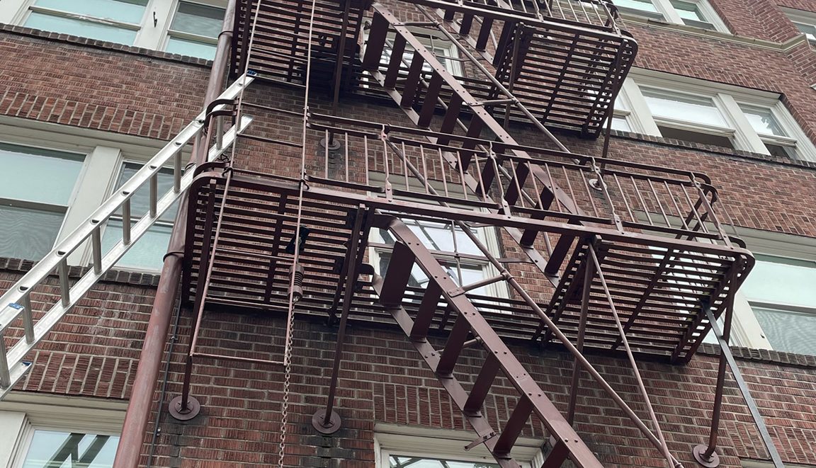 Fire escape on a brick apartment building in Portland, Oregon — tested and certified by K&H Construction