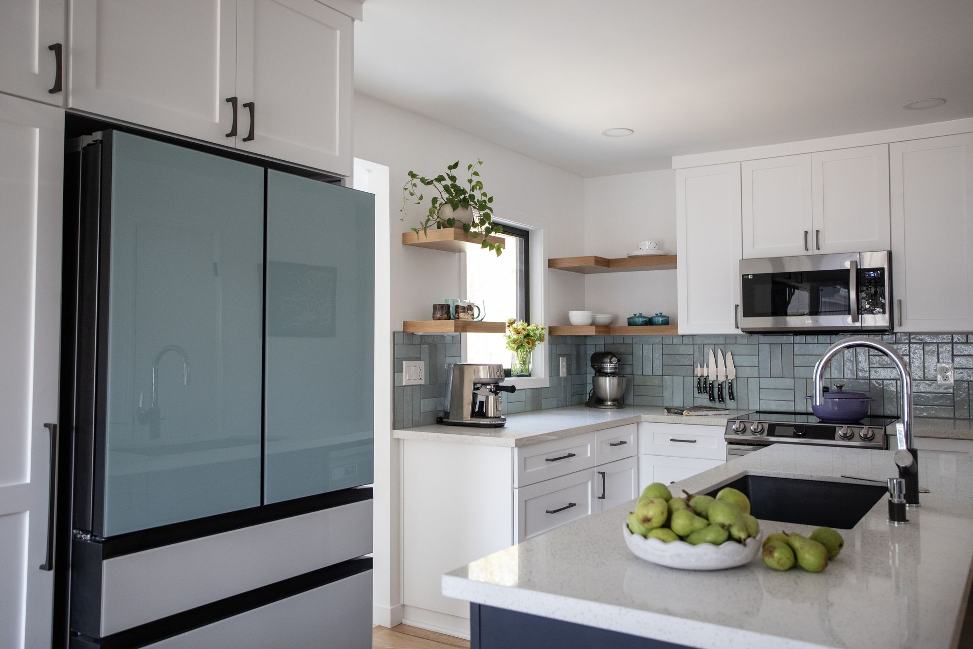 Portland kitchen remodel by K&H Construction — white shaker cabinets, handmade blue-green tile backsplash, navy island, and floating oak shelves